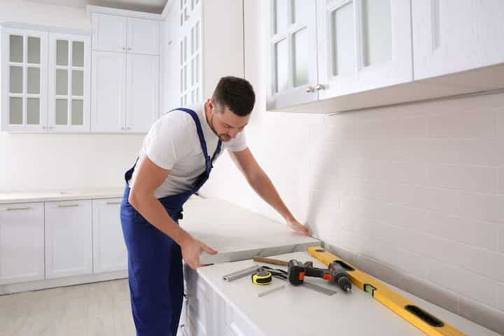 An expert kitchen remodeling contractor working on countertop in Manassas, Virgina home